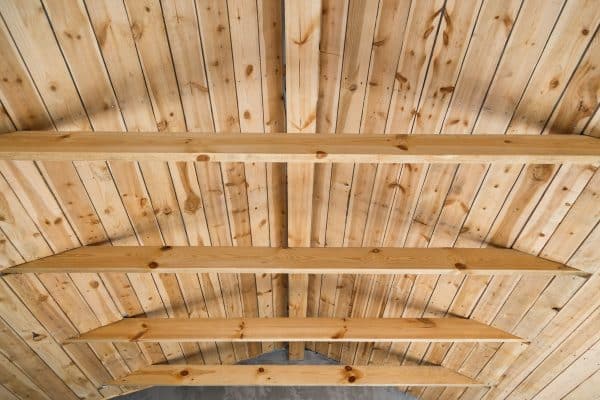 Holzbalkendecke aus hellen Brettern und stabilen Trägern.